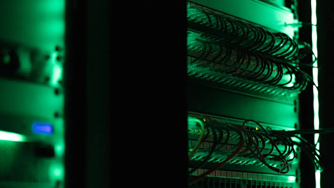 Data center monitoring station with multiple screens and control interfaces.