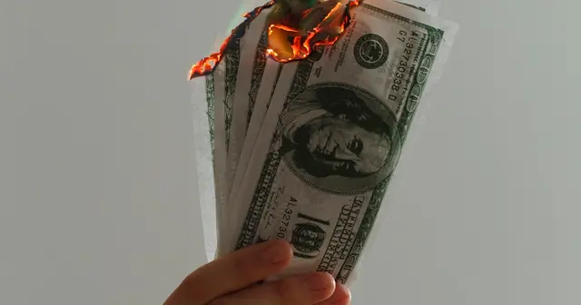 Time-lapse photograph of US dollar banknotes on fire